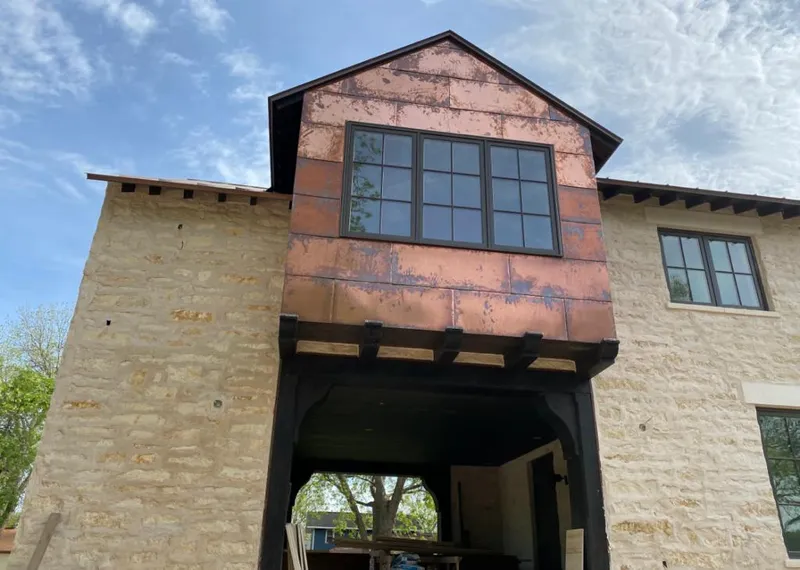 Copper metal panel facade on a stone building for Skylight Installation in Terrell