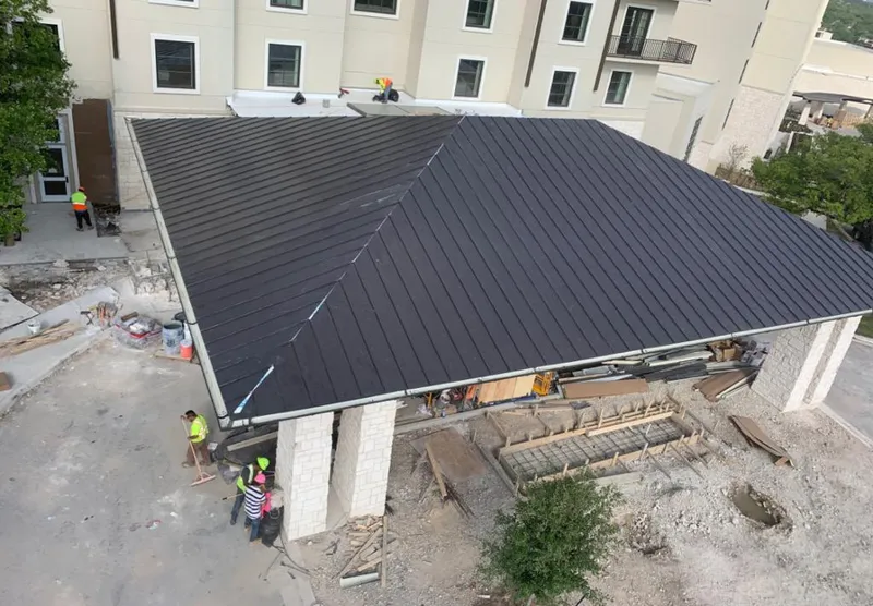 Metal roofing installation team working on a commercial building in Terrell