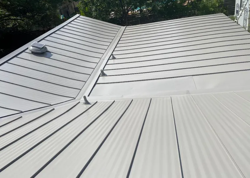 Solar attic fan installed on a metal roof for Roof Ventilation in Terrell